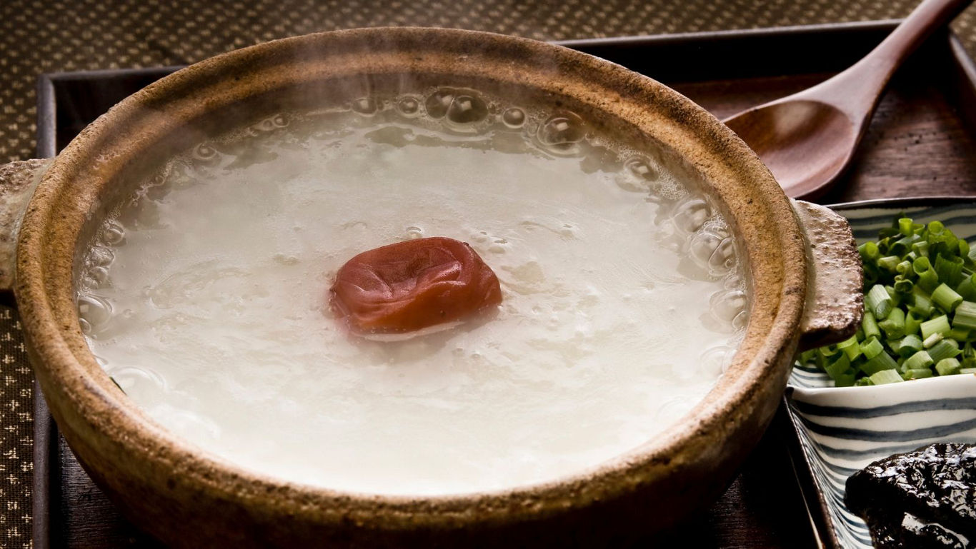Steaming rice porridge with pickled plum garnish