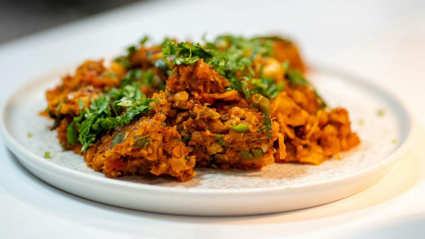 Spiced vegetable fritters garnished with fresh herbs