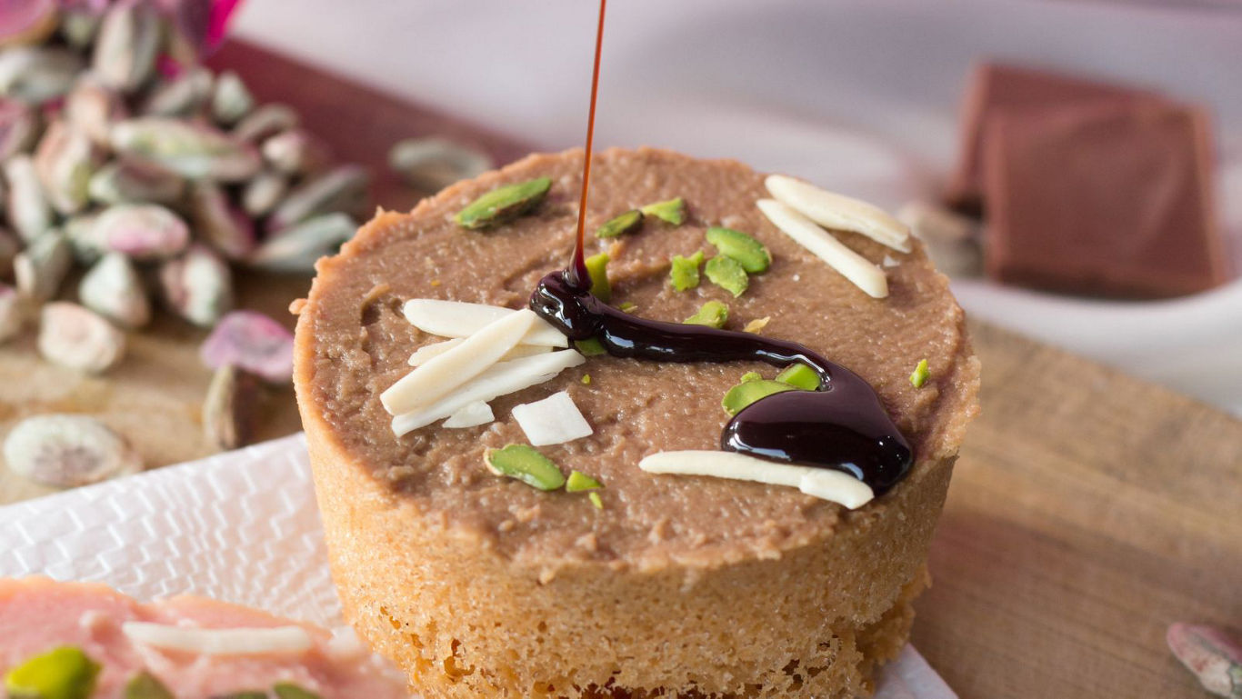 Gourmet dessert with chocolate drizzle and nuts