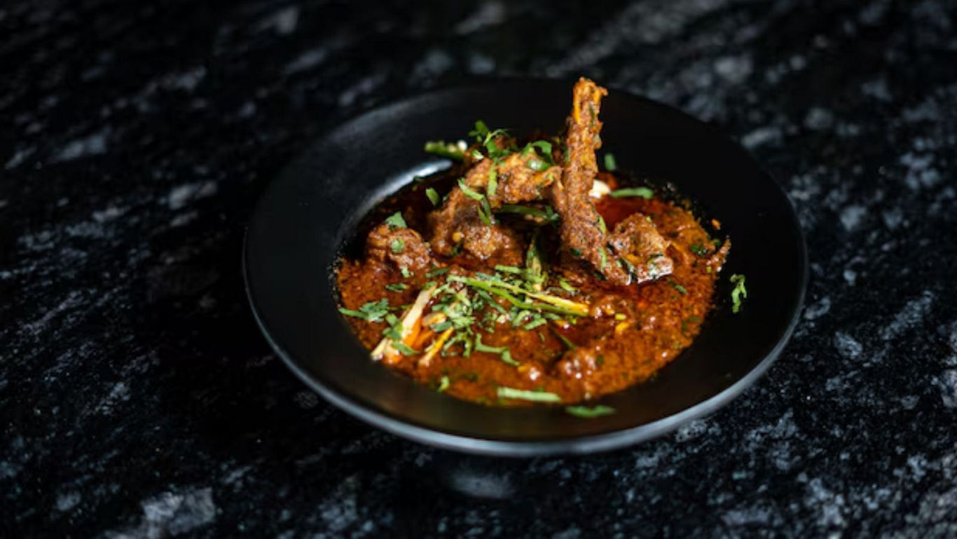Spicy Lamb Curry Served in Black Bowl on Marble