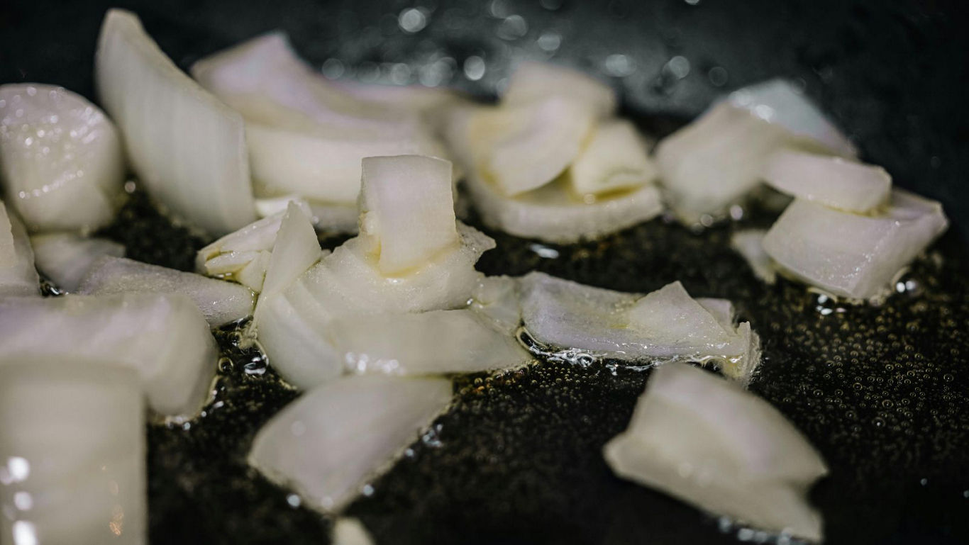 Chopped onions sizzling in hot oil