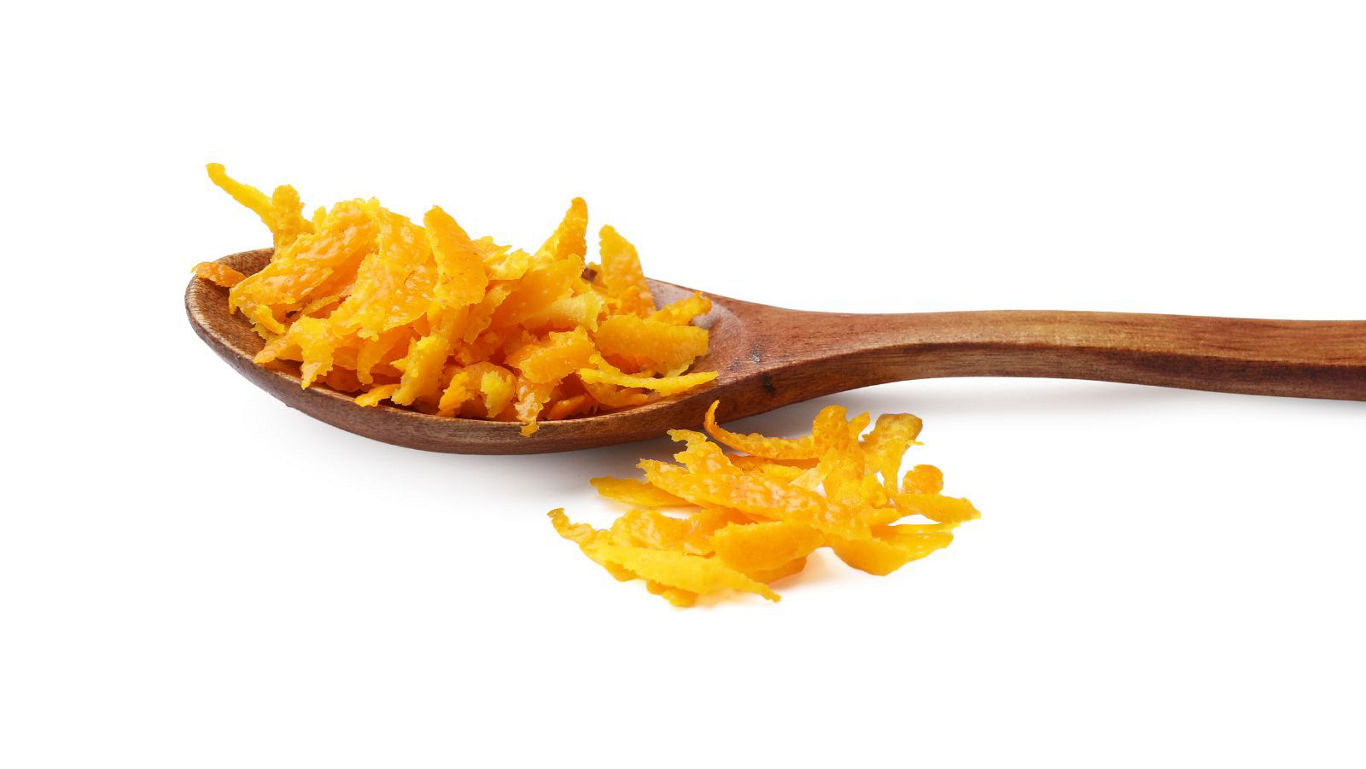 Wooden spoon with orange citrus zest