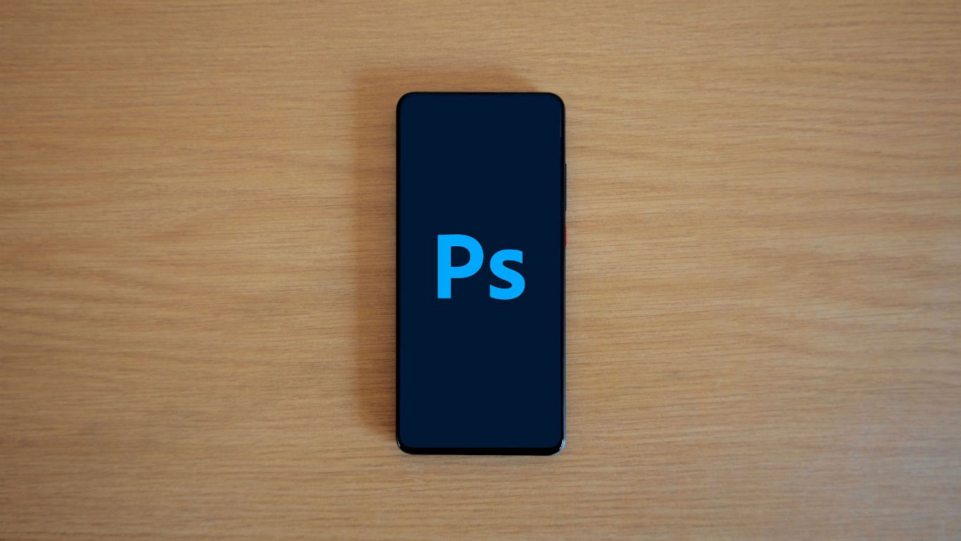Smartphone on wooden desk with Ps screen