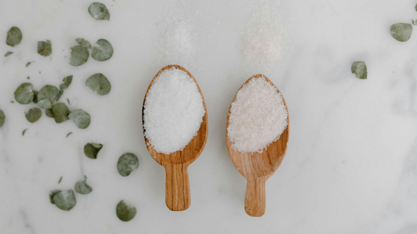 Wooden scoops with white and pink salts