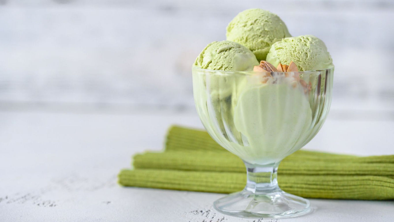 Green tea ice cream scoops in glass dessert bowl