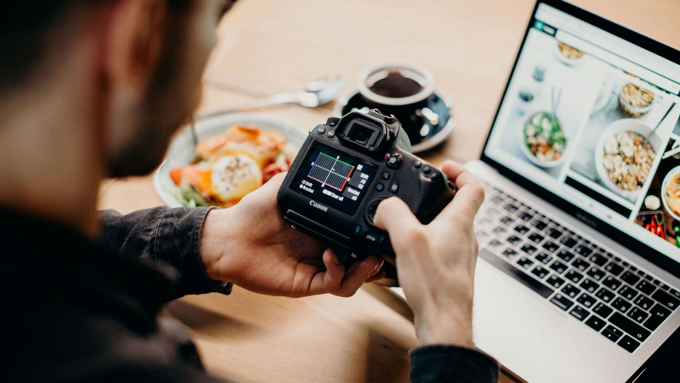 Photographer reviewing food shots on camera