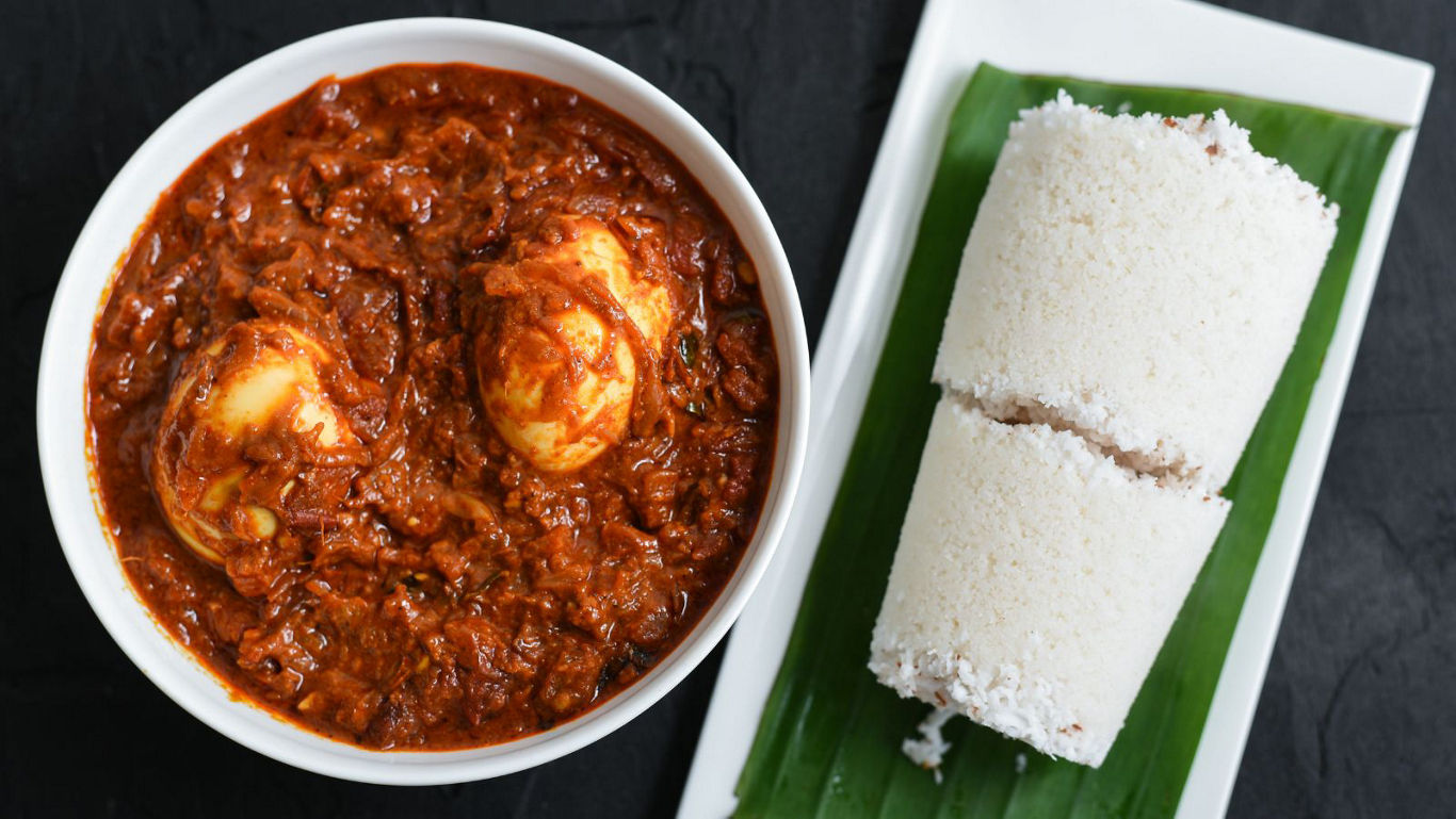 Spicy egg curry served with steamed puttu