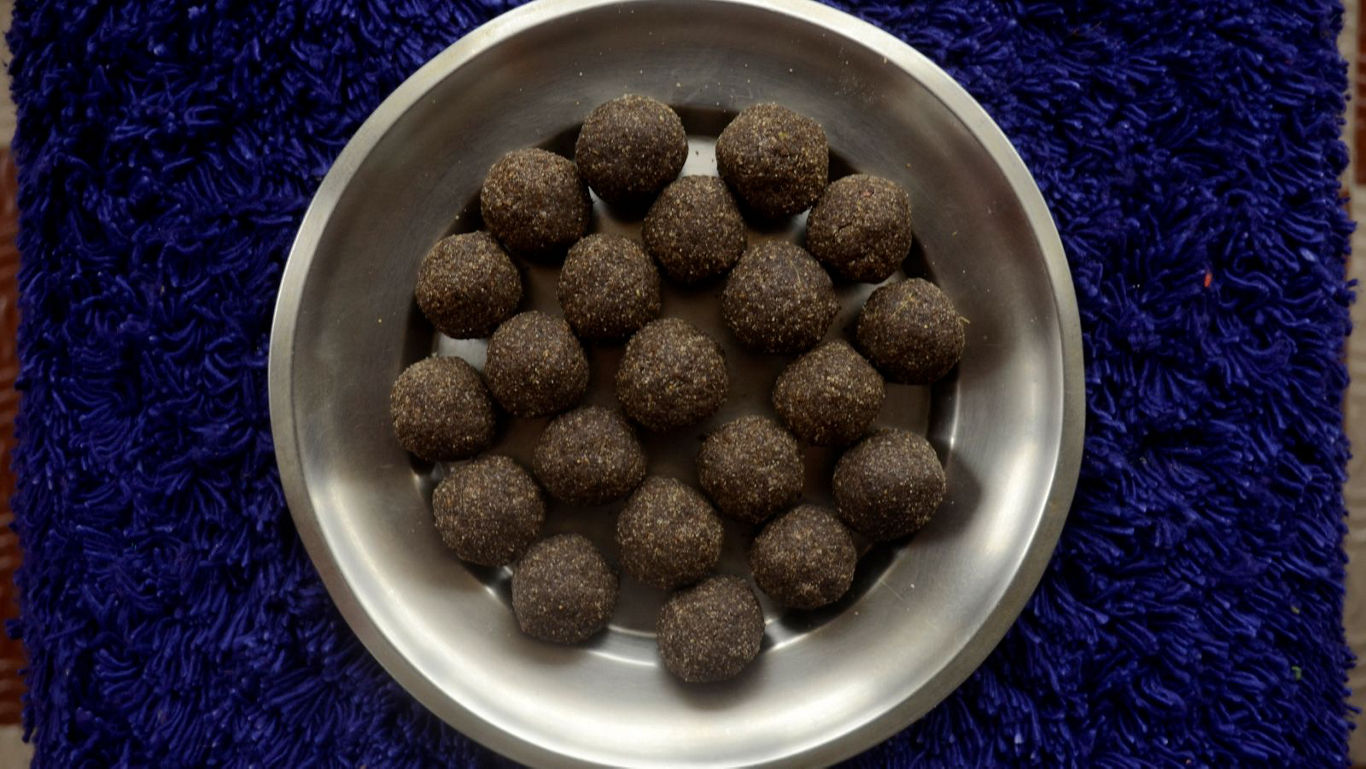 Round chocolate dessert balls in metal bowl