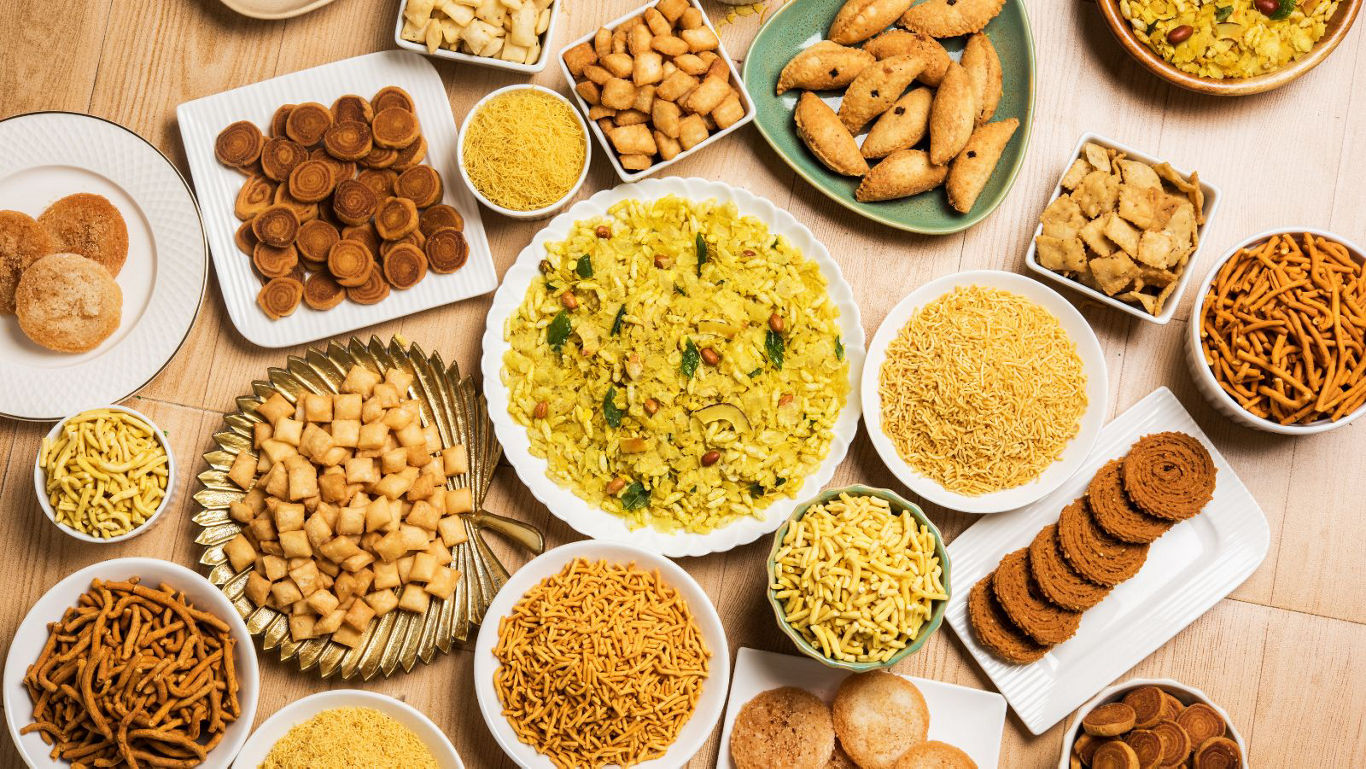 Assorted Indian snacks and sweets on table