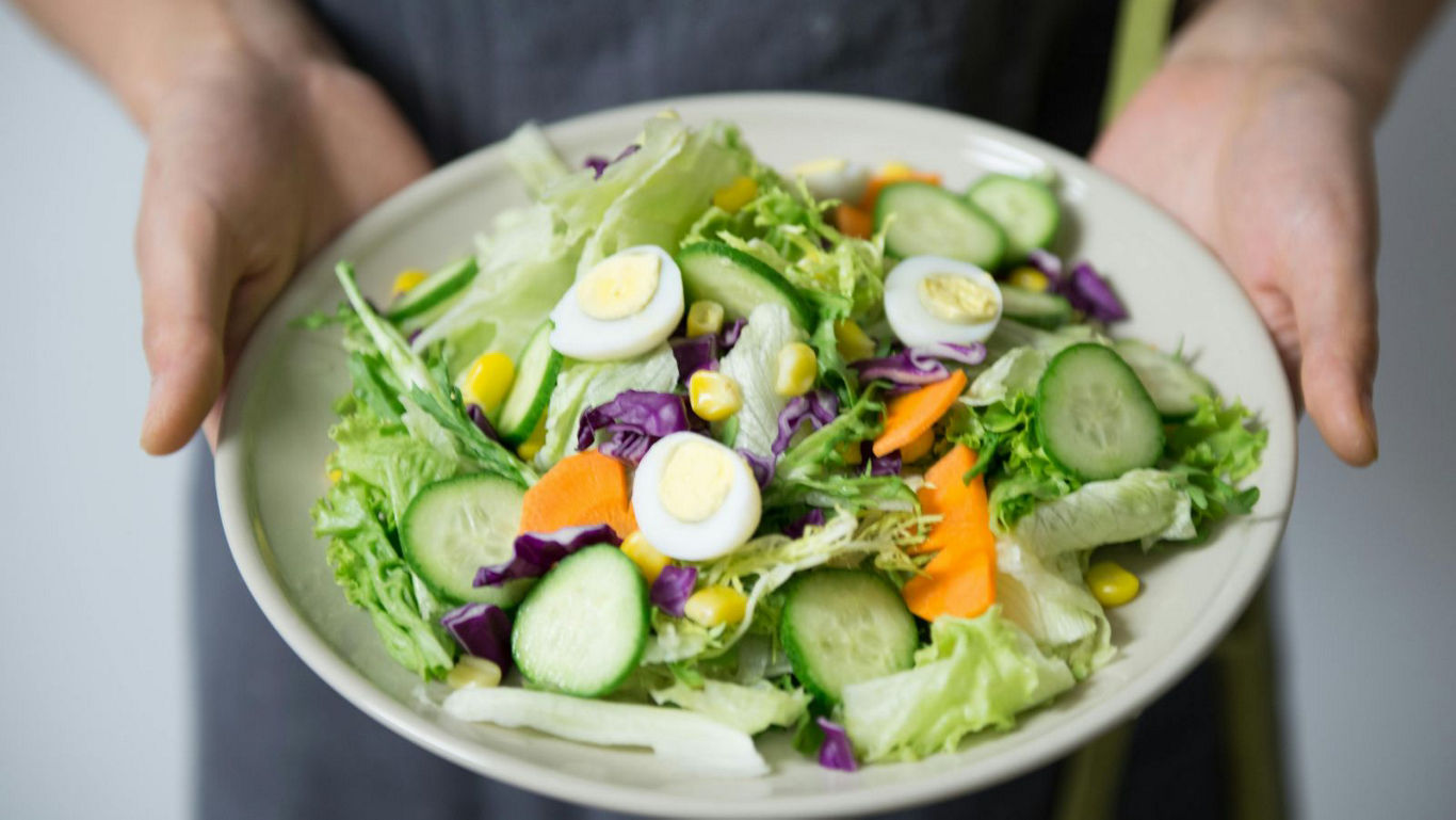 Fresh vegetable salad with sliced boiled eggs