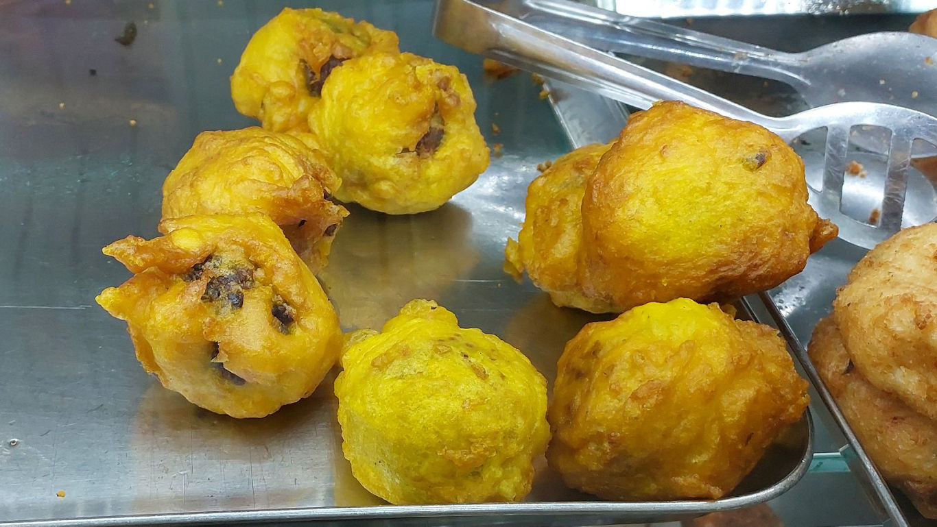 Golden deep-fried snack balls on tray