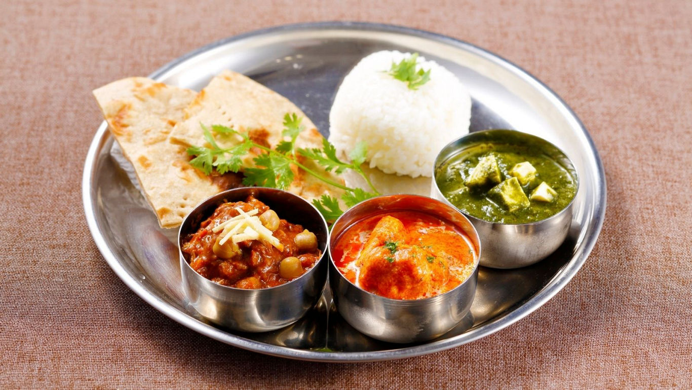 Indian thali with curries, rice and flatbread