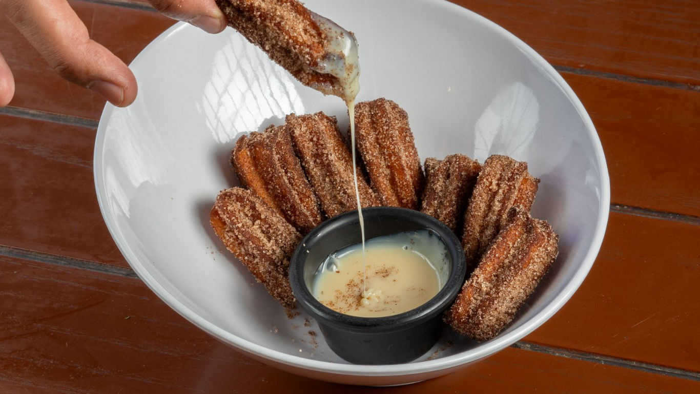Cinnamon churros dipped in sweet sauce