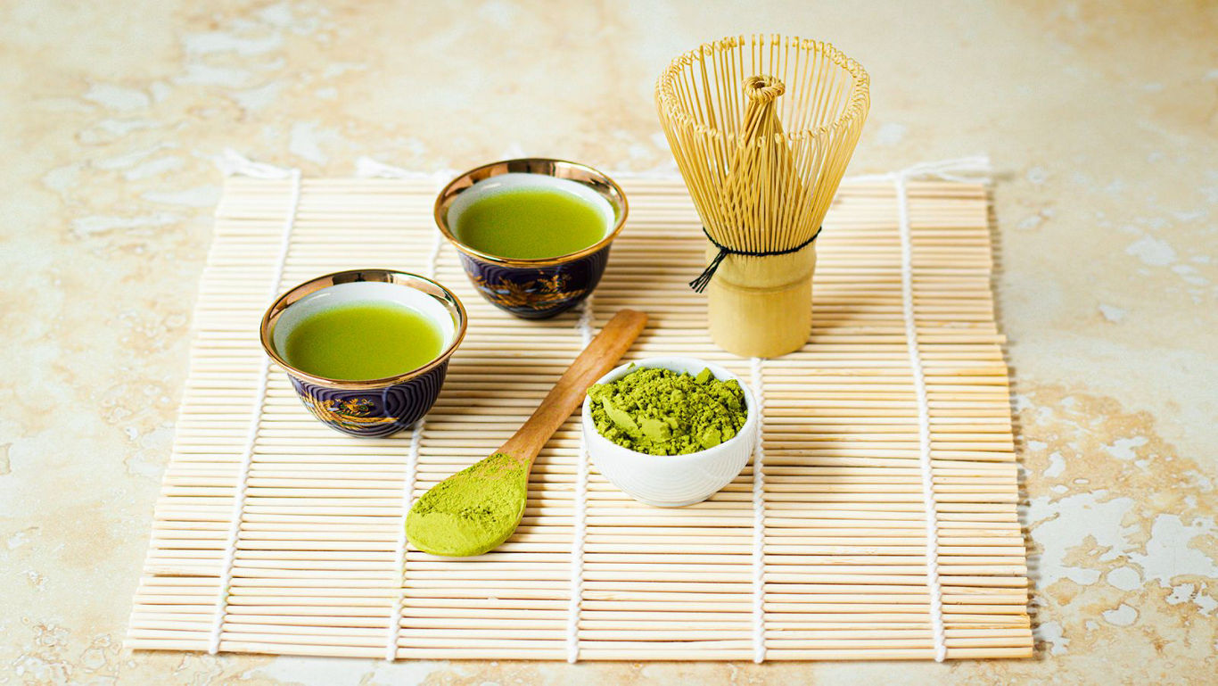 A top-view image of matcha and its preparation tools.