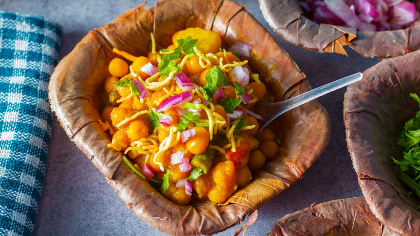 Indian street-style chickpea chaat in leaf bowl