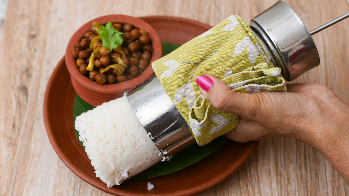 Hand serving steamed rice dish with curry