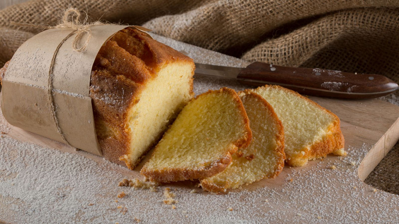 Sliced pound cake on rustic wooden board