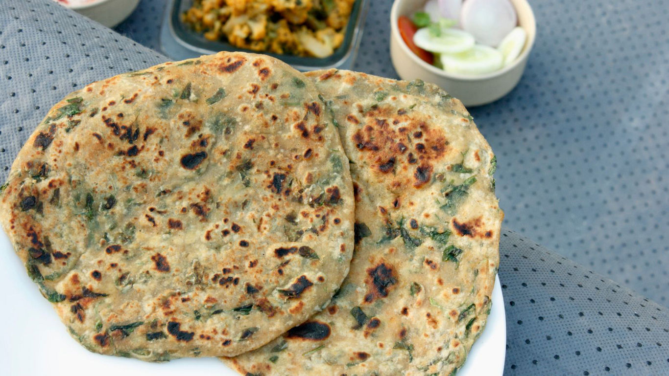 Close-up of Indian paratha with side dishes