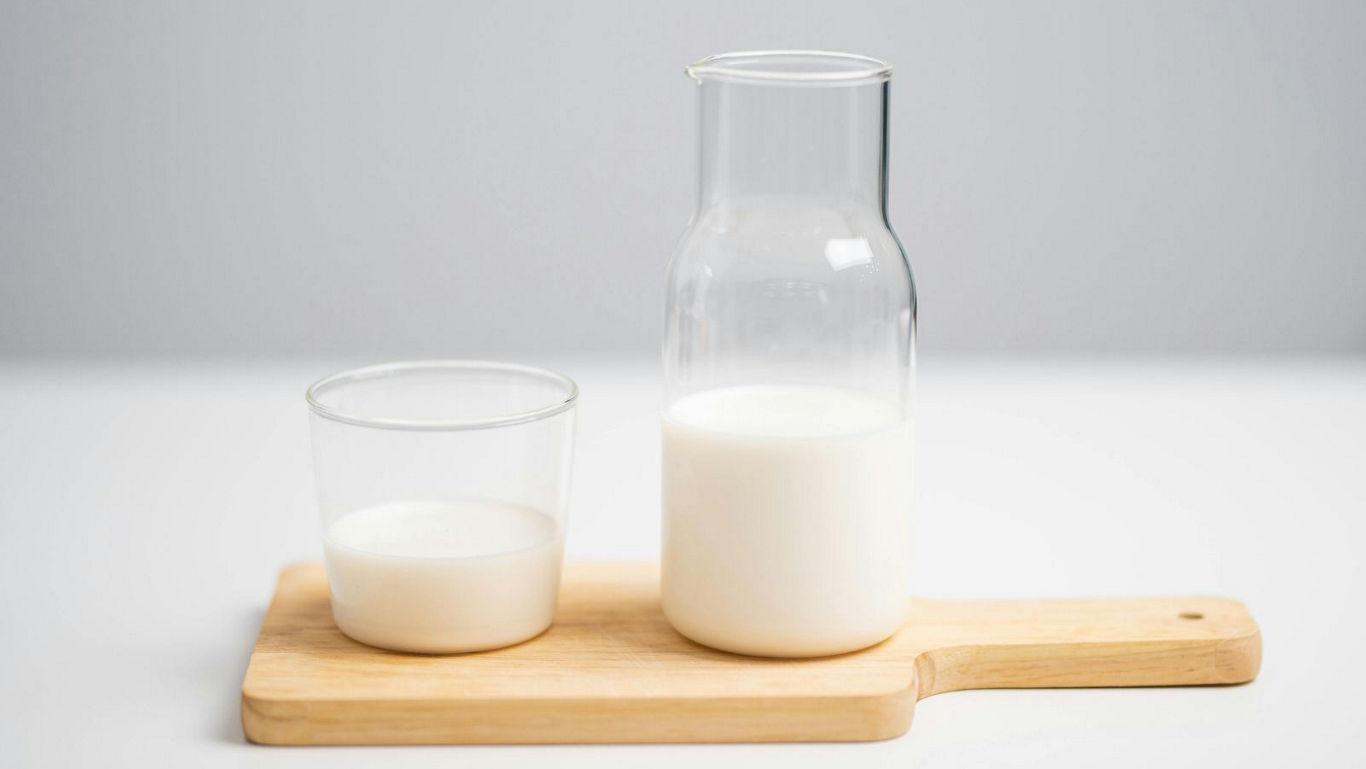 Glass carafe and cup of milk