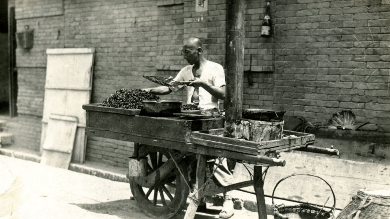 Street vendor preparing food at wooden cart