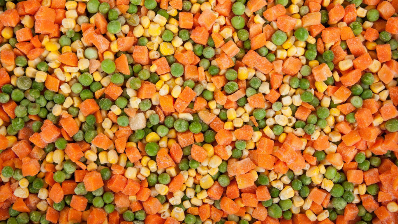 Colorful mixed diced vegetables background