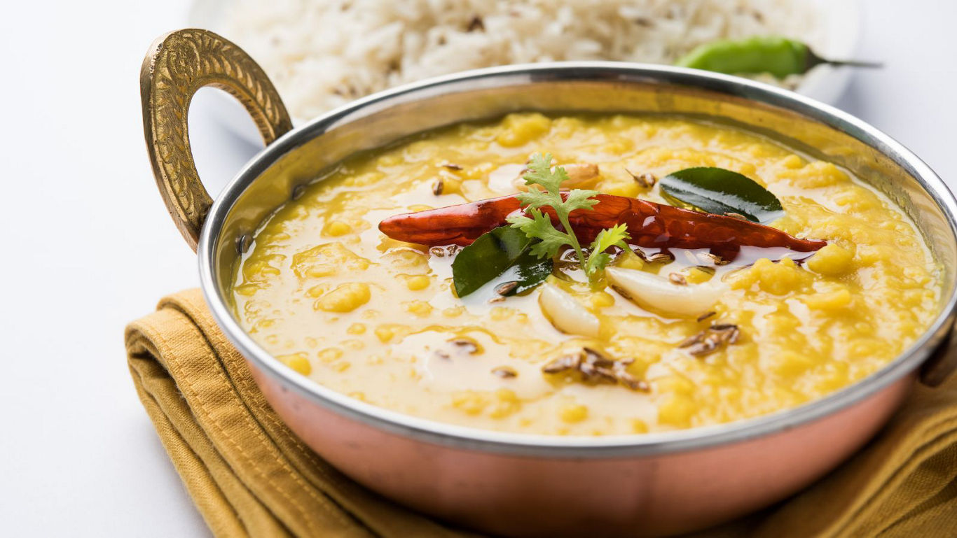 Traditional Indian lentil curry in copper bowl