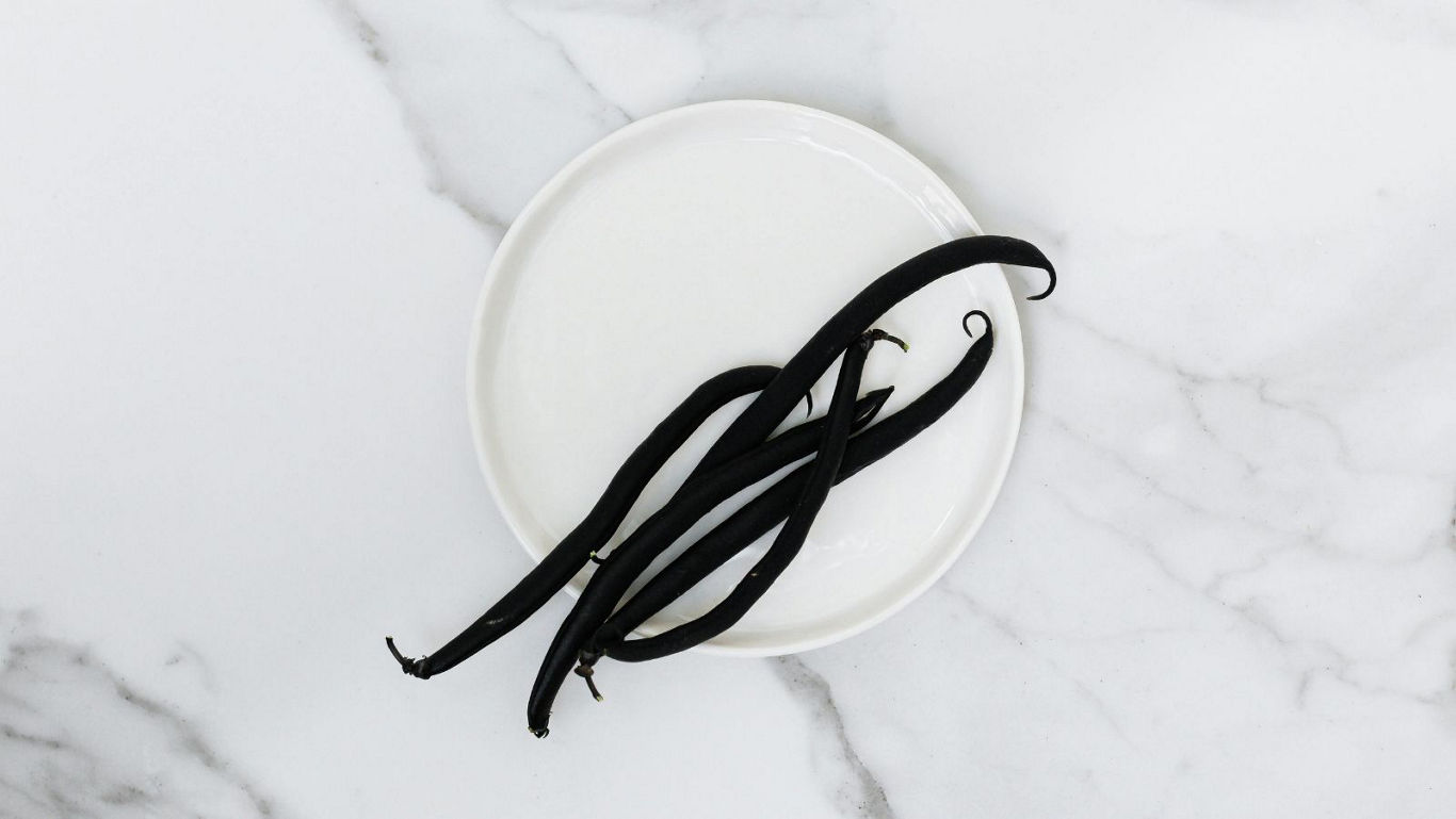 Whole Vanilla Beans on White Ceramic Plate