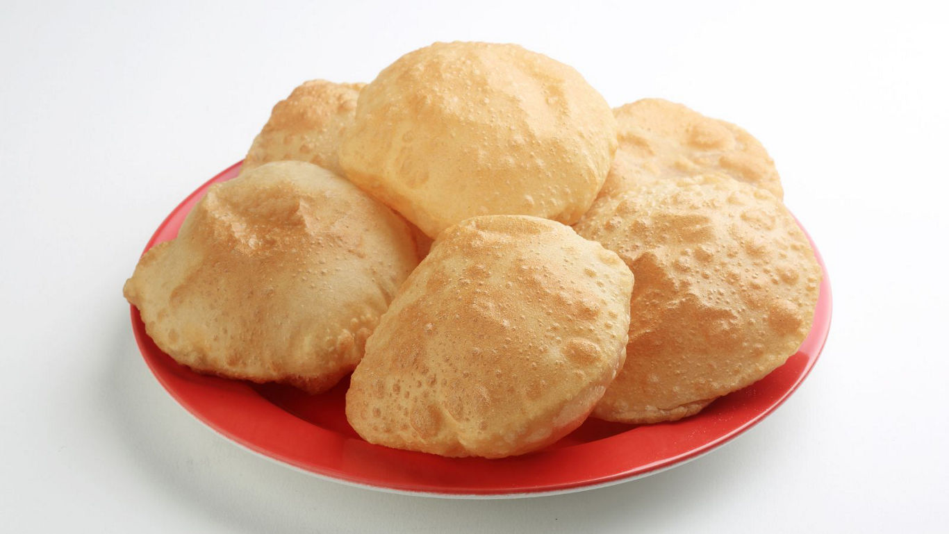 Plate of golden fried puffed bread
