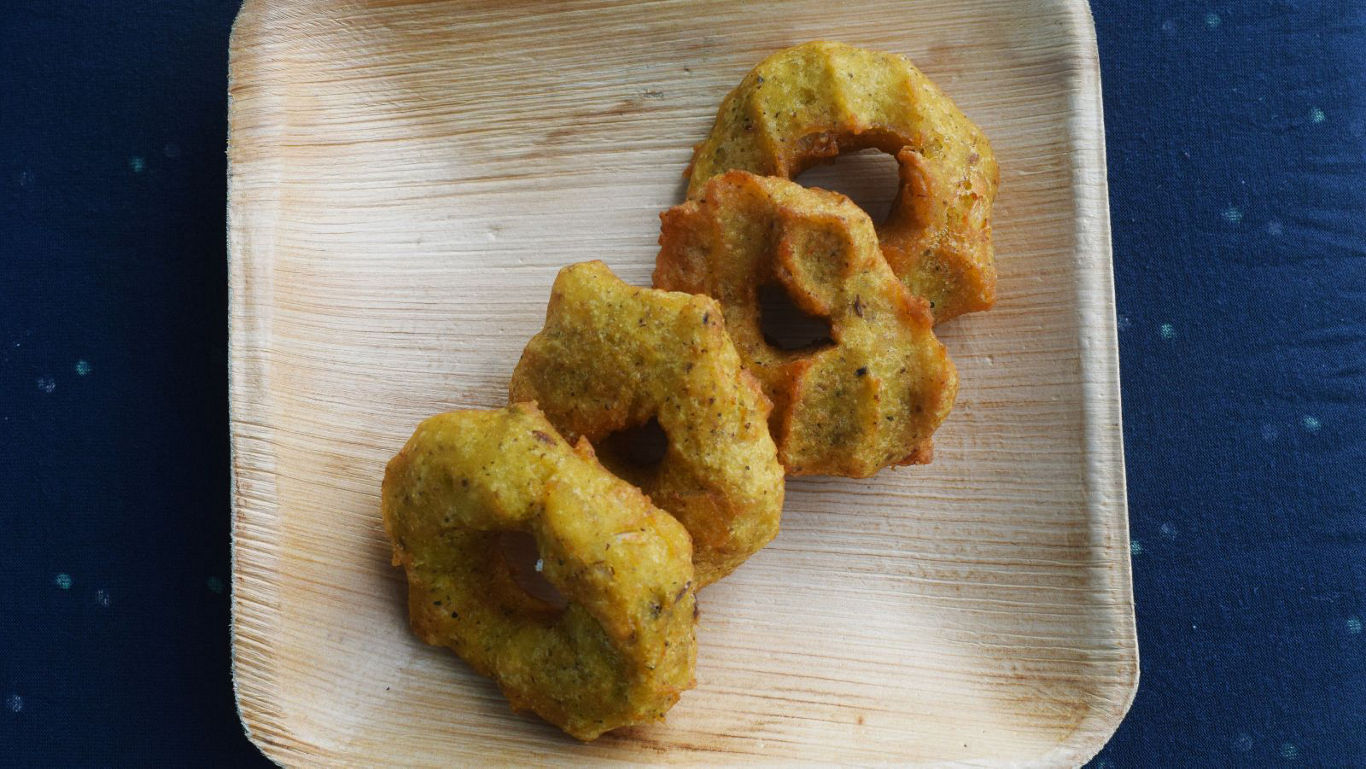 Three savory fried snacks on tray