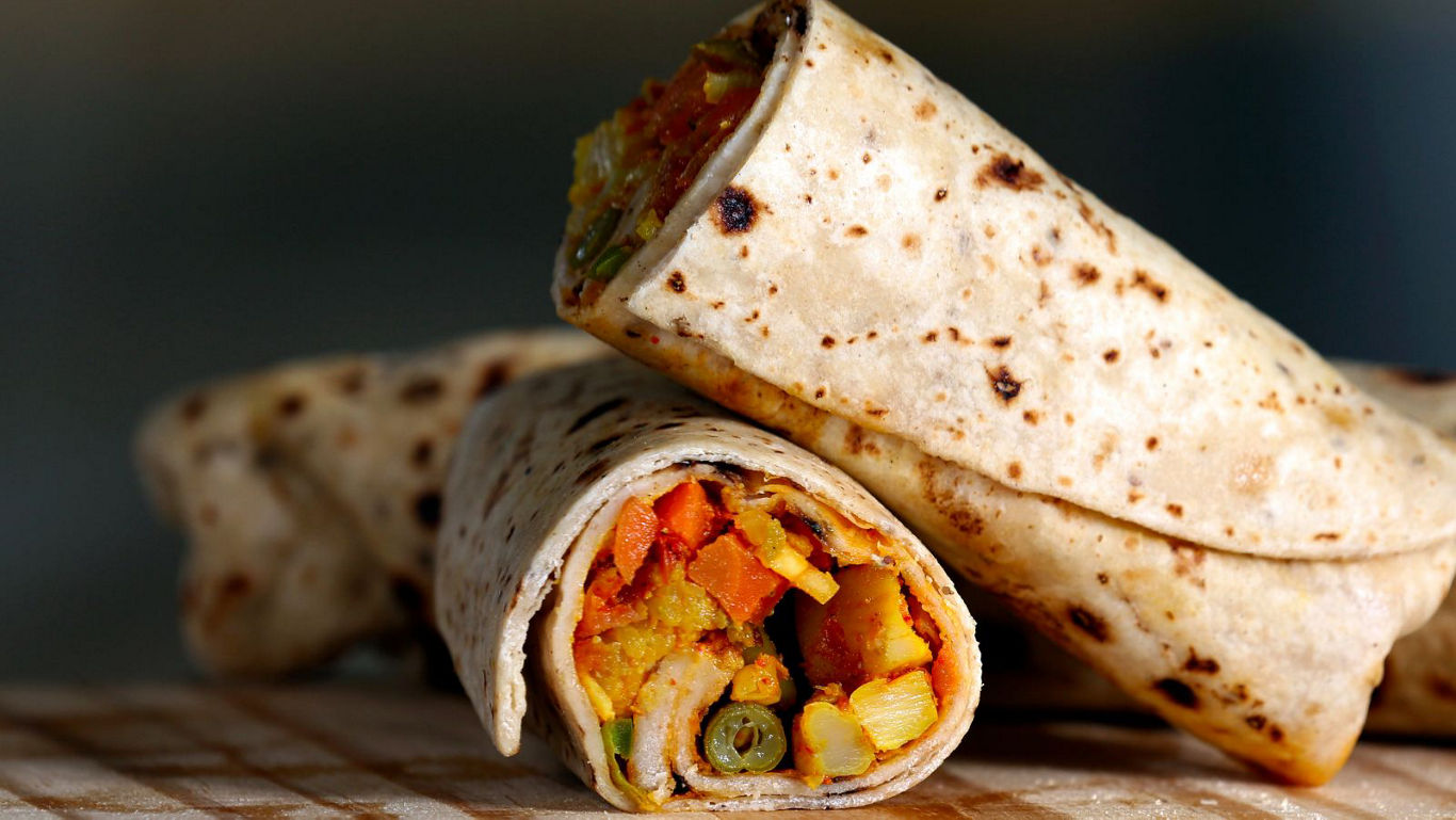 Close-up of vegetable stuffed tortilla wraps on table