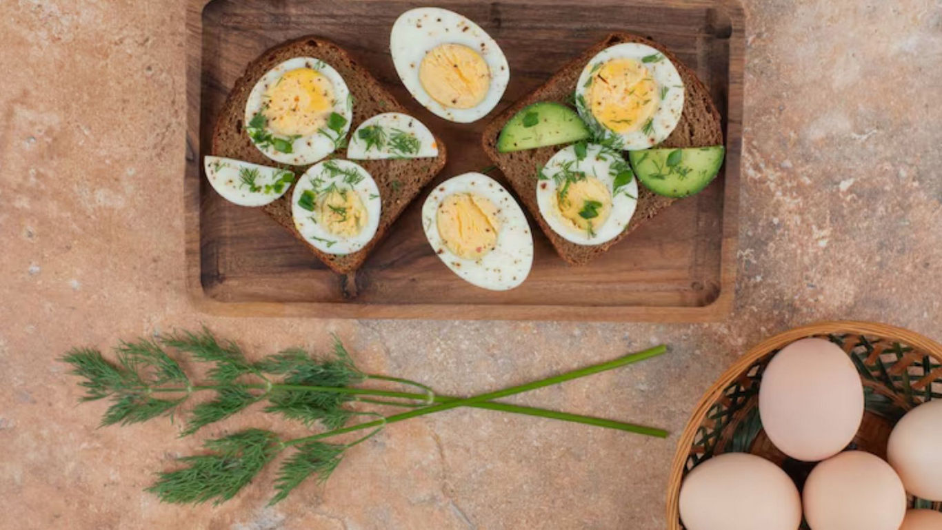 Boiled eggs on toast with avocado