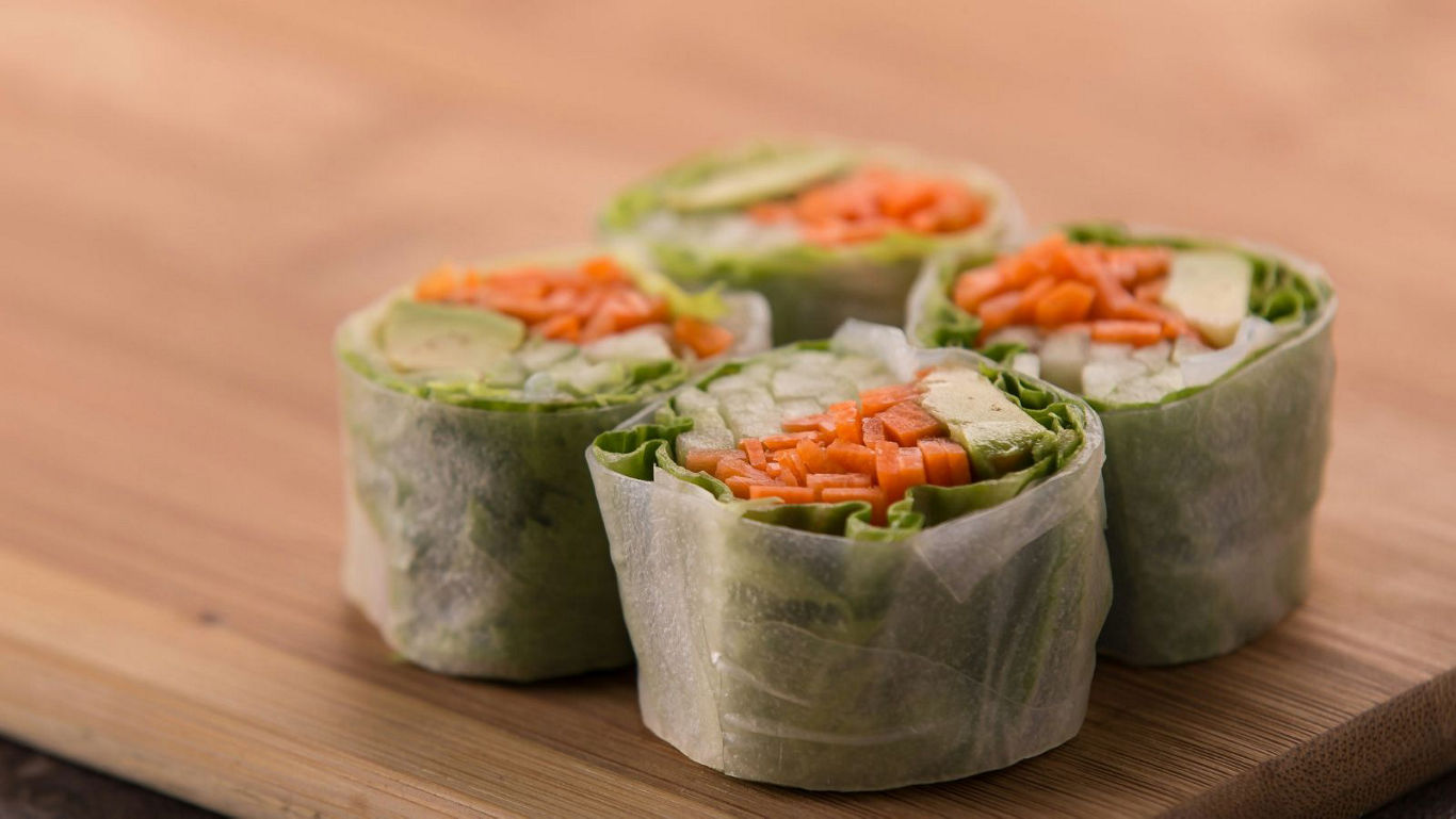 Fresh vegetable spring rolls on wooden board