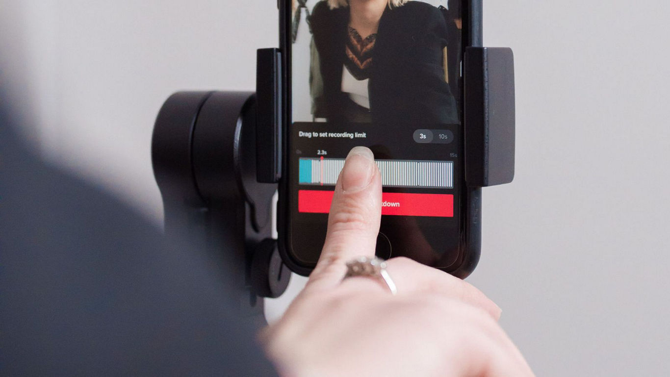 Person editing video clip on smartphone