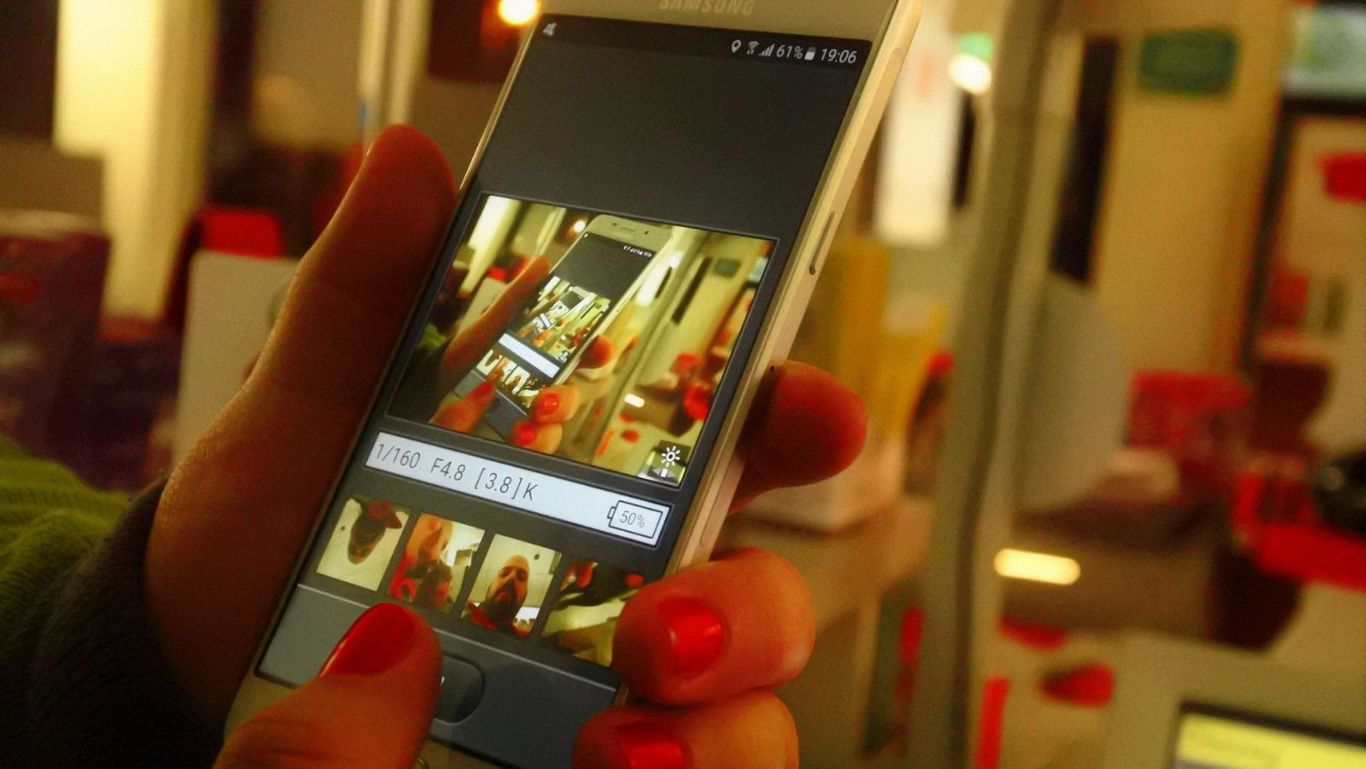 Person editing photo on smartphone screen