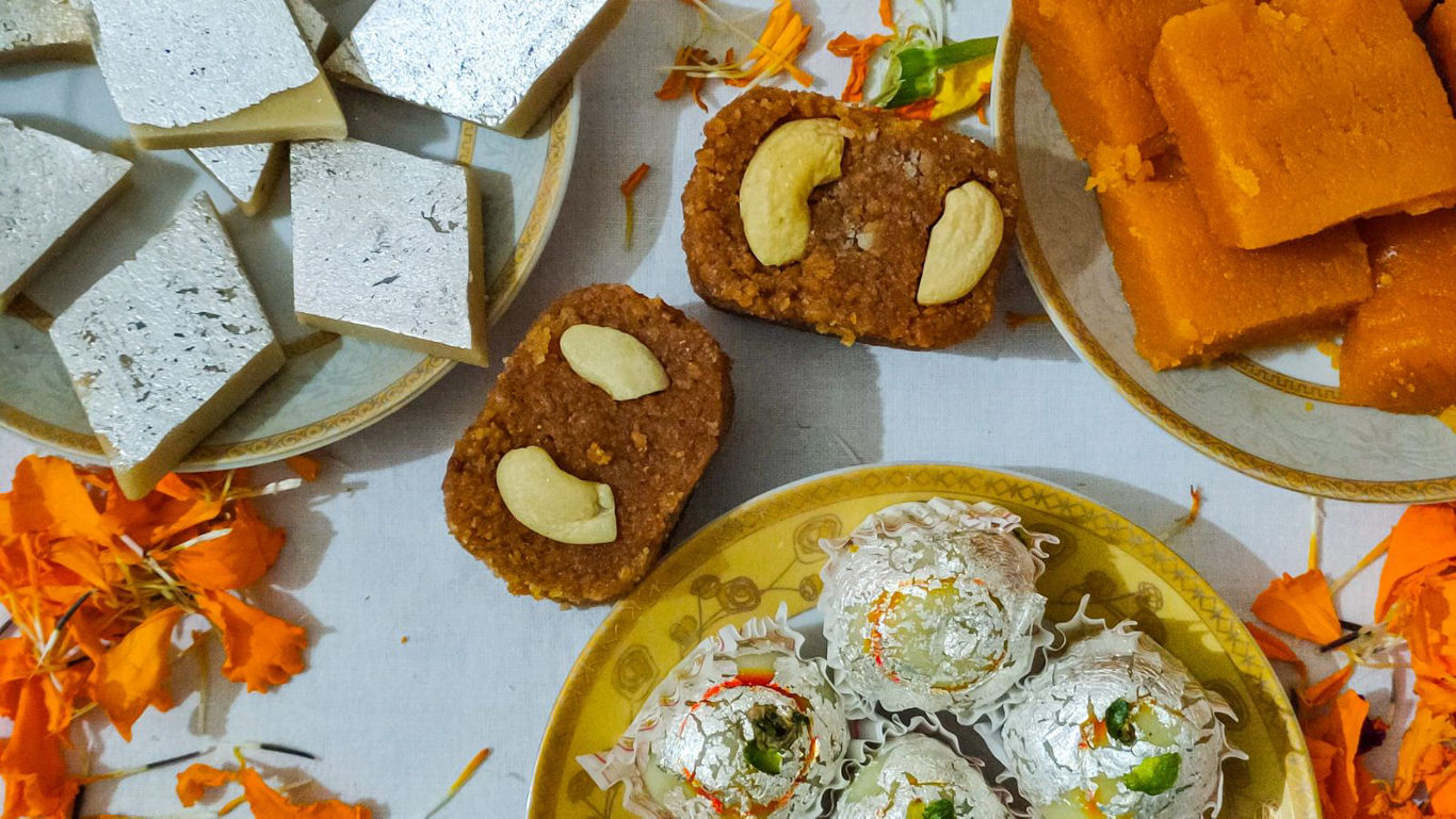 Assorted Indian sweets with festive decor