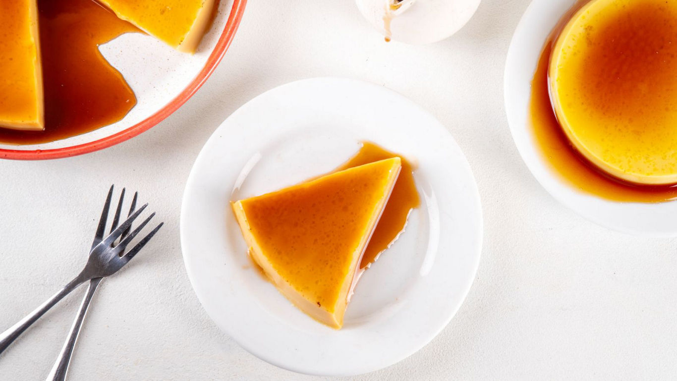 Slice of caramel flan on white plates