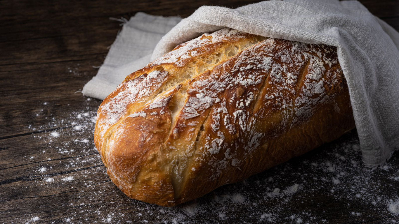 Rustic loaf of bread on wooden table