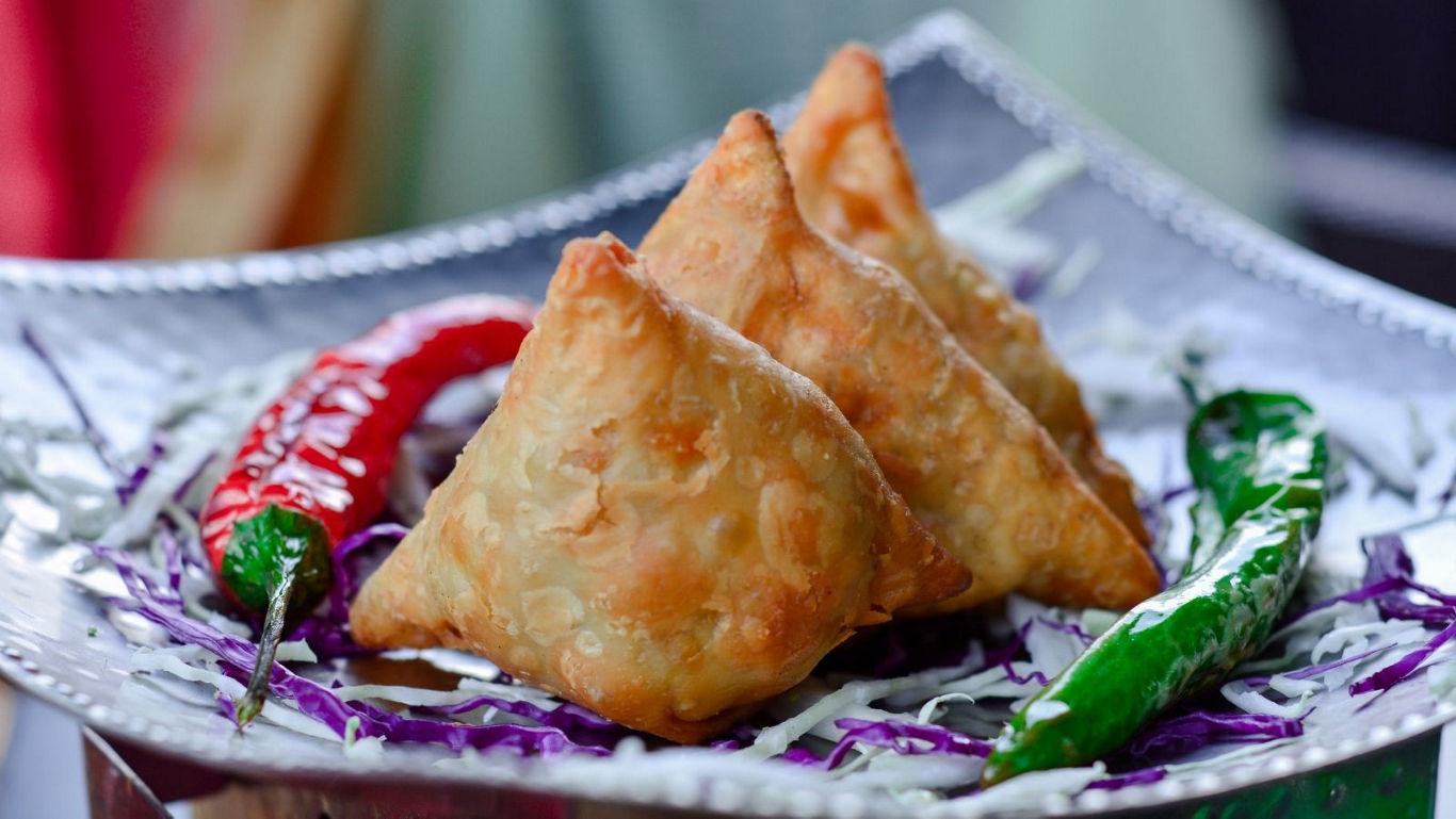 Crispy vegetable samosas with chili peppers