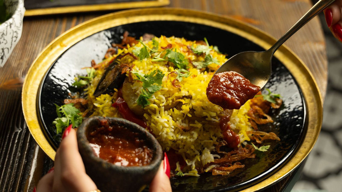Spiced rice dish served with red chutney