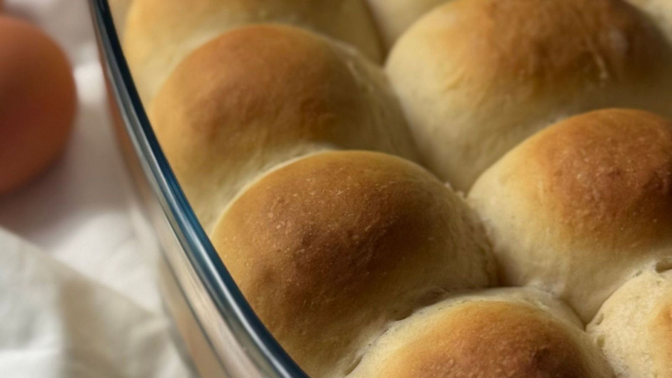 Freshly baked golden dinner rolls in dish