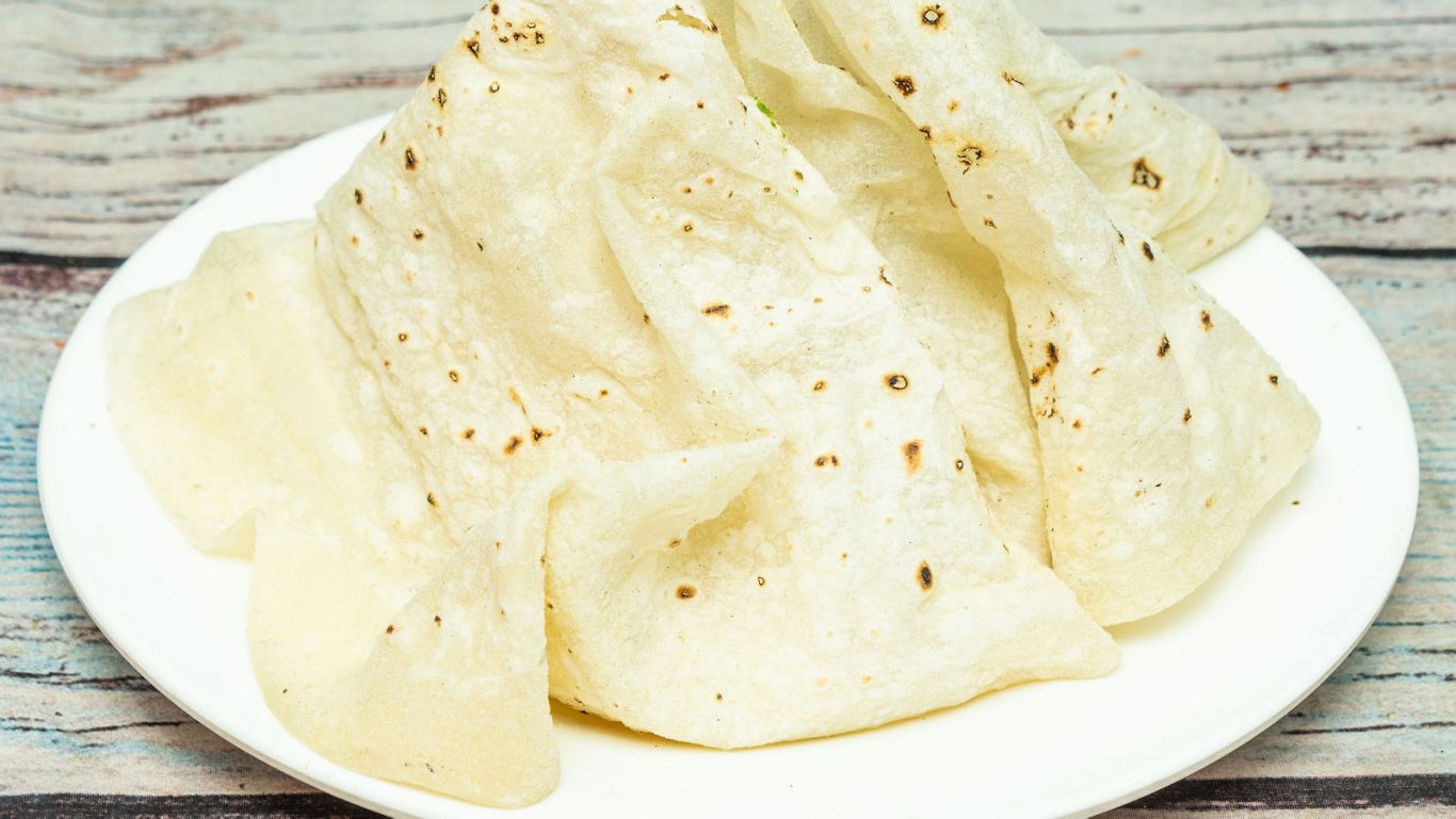 Stack of thin flatbreads on plate