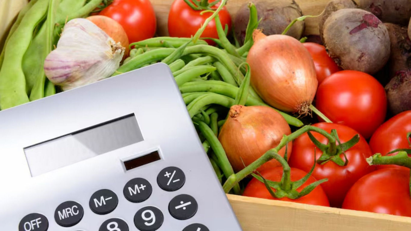 Calculator with fresh vegetables in a crate