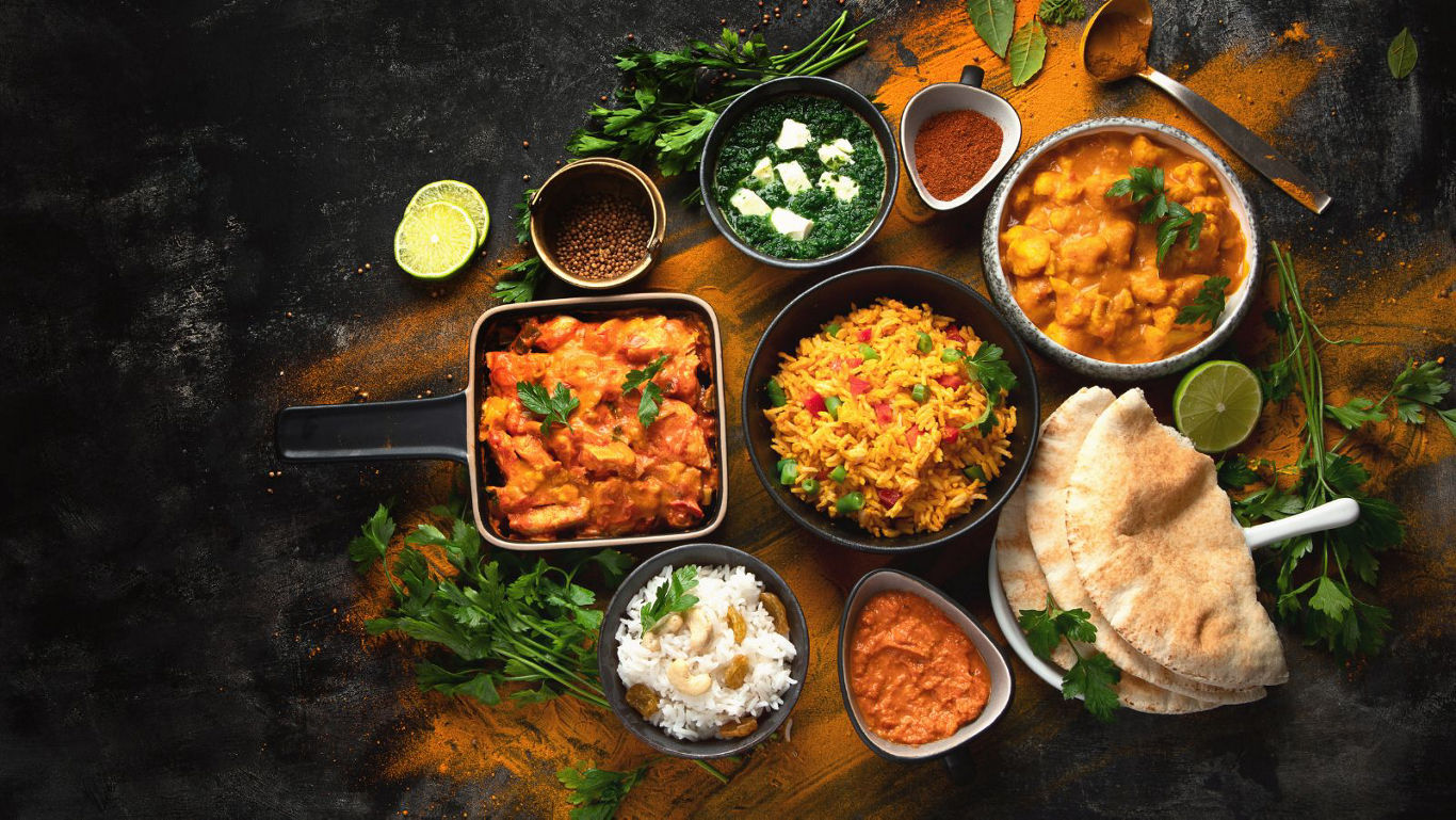 Assorted Indian dishes with rice and naan