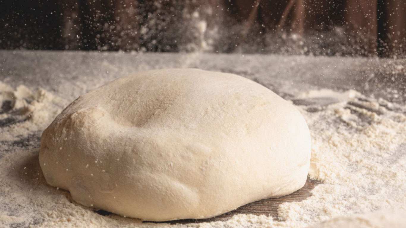 Fresh bread dough dusted with flour