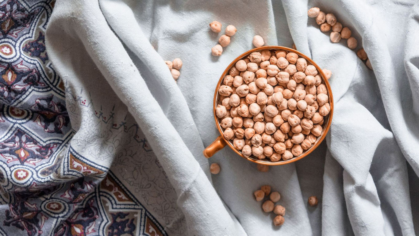 Bowl of dried chickpeas on fabric