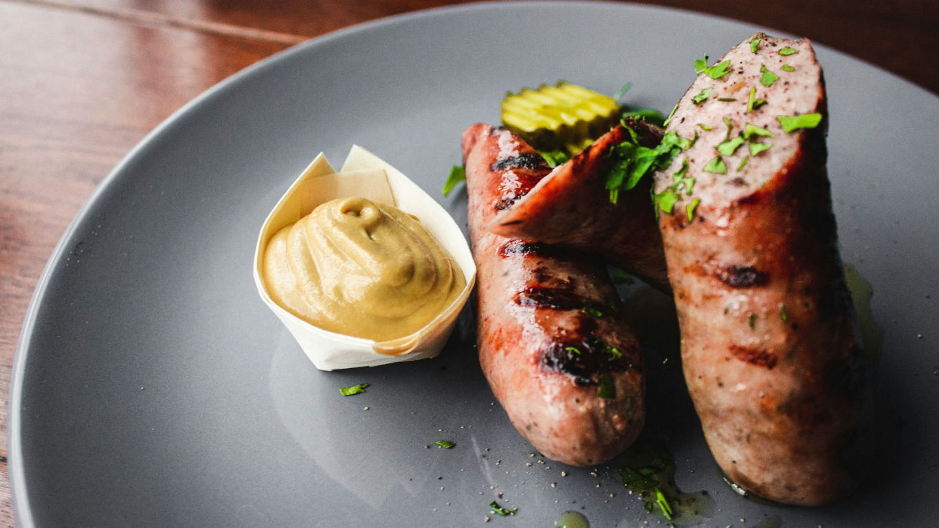 Grilled sausages with mustard and pickles