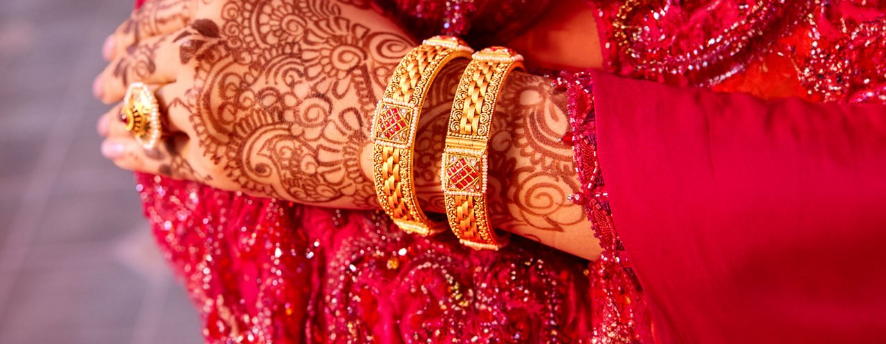 Woman Wearing Traditional Gold Bangles