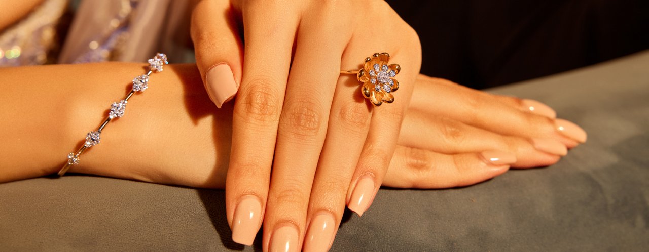 Woman showcasing diamond ring & bangles