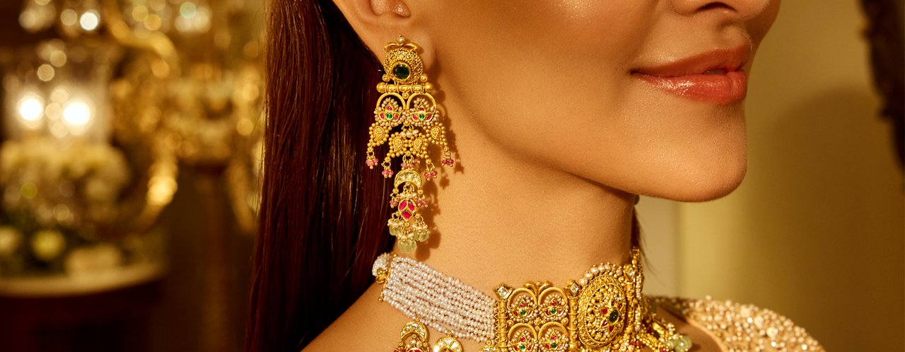 Traditional Gold Earrings With Intricate Detailing, Paired With a Matching Necklace