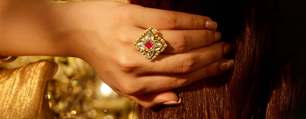 Ornate Gold Ring With a Red Gemstone